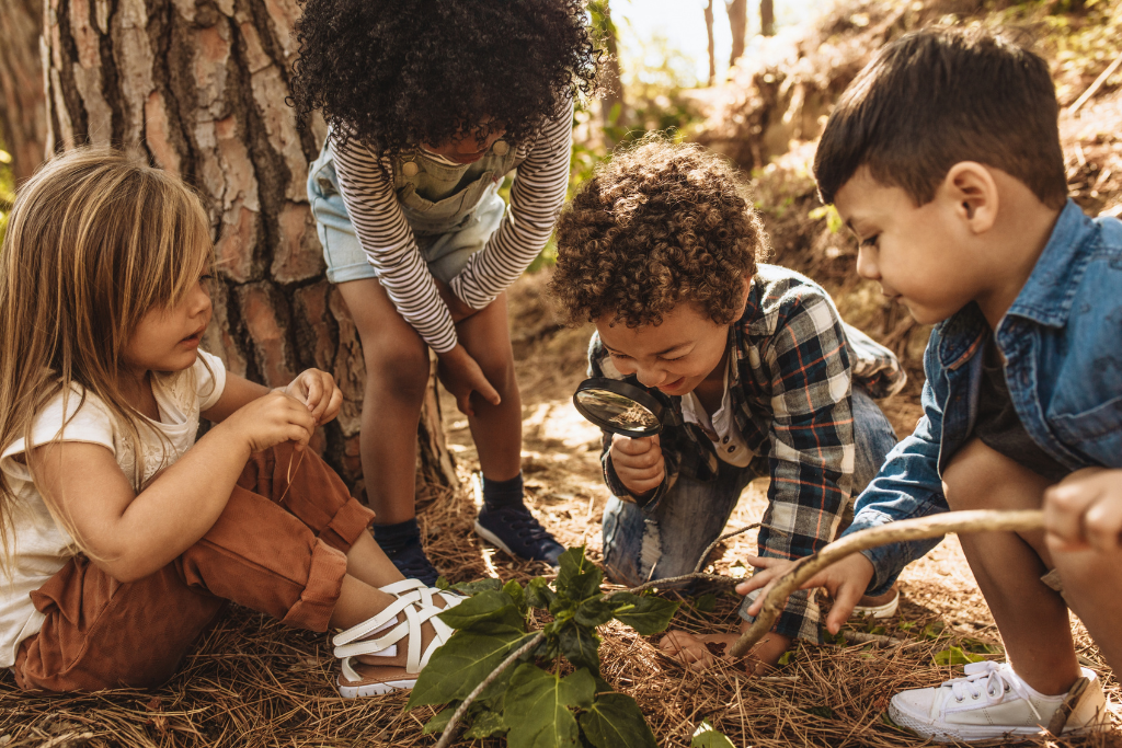 kids using magnifying glasses to explore nature